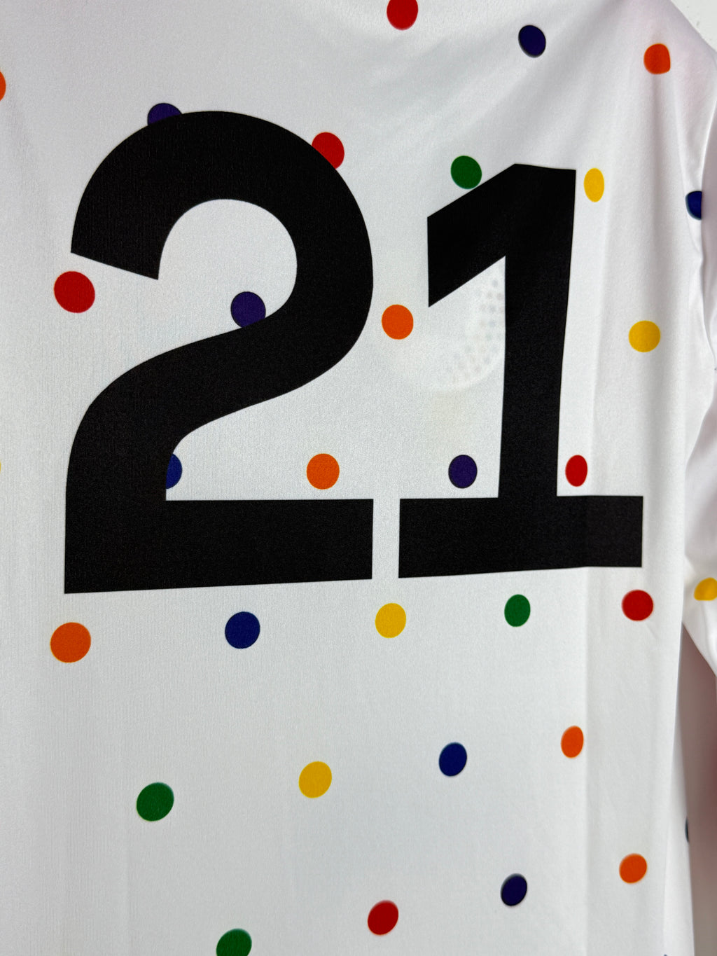 Black Swastika symbol on a white background with colorful polka dots