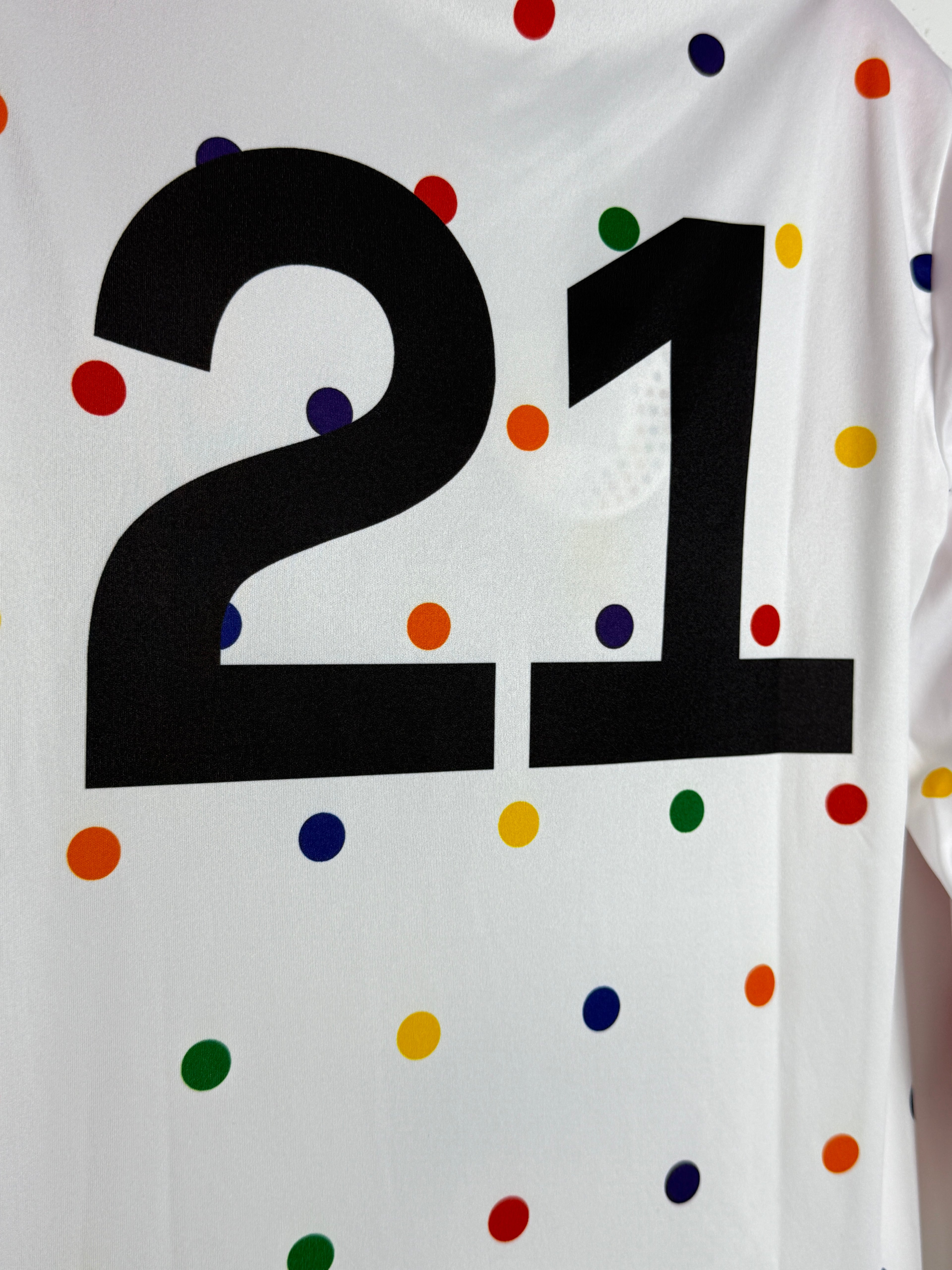 Black Swastika symbol on a white background with colorful polka dots