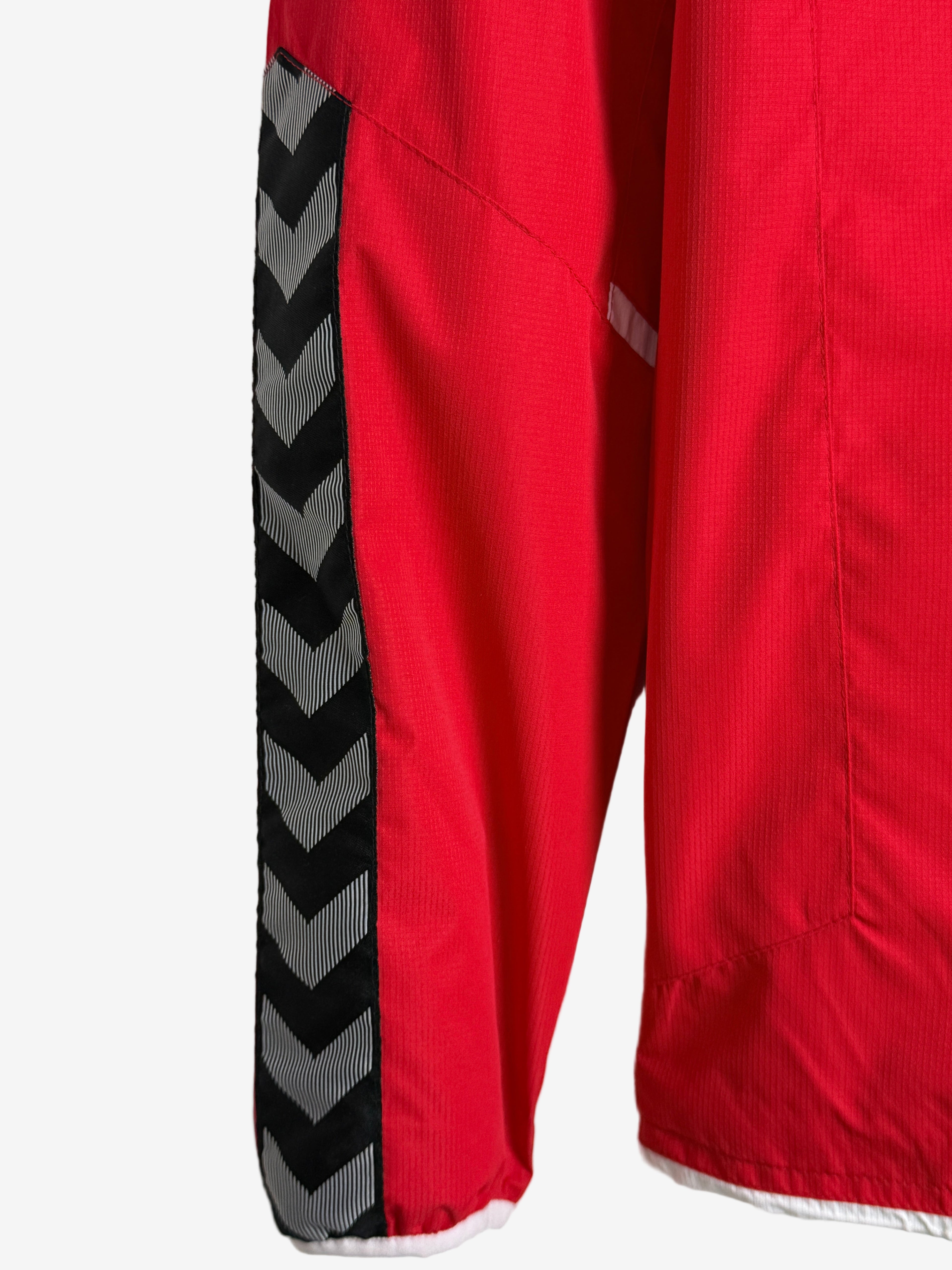Close-up of red pants with a black and gray striped band on a white background
