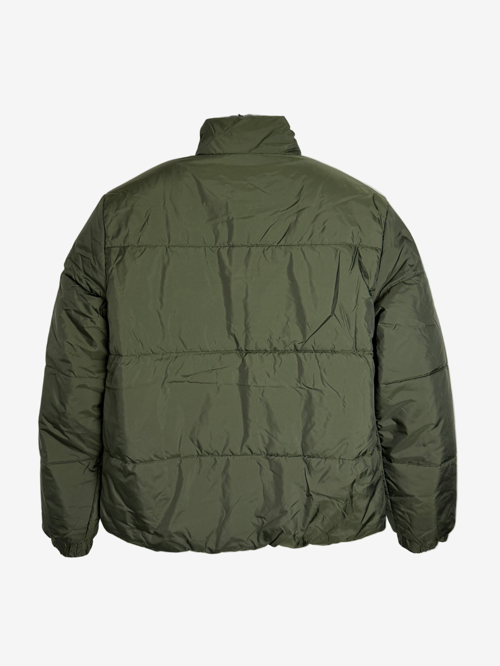 Green puffer jacket on a white background