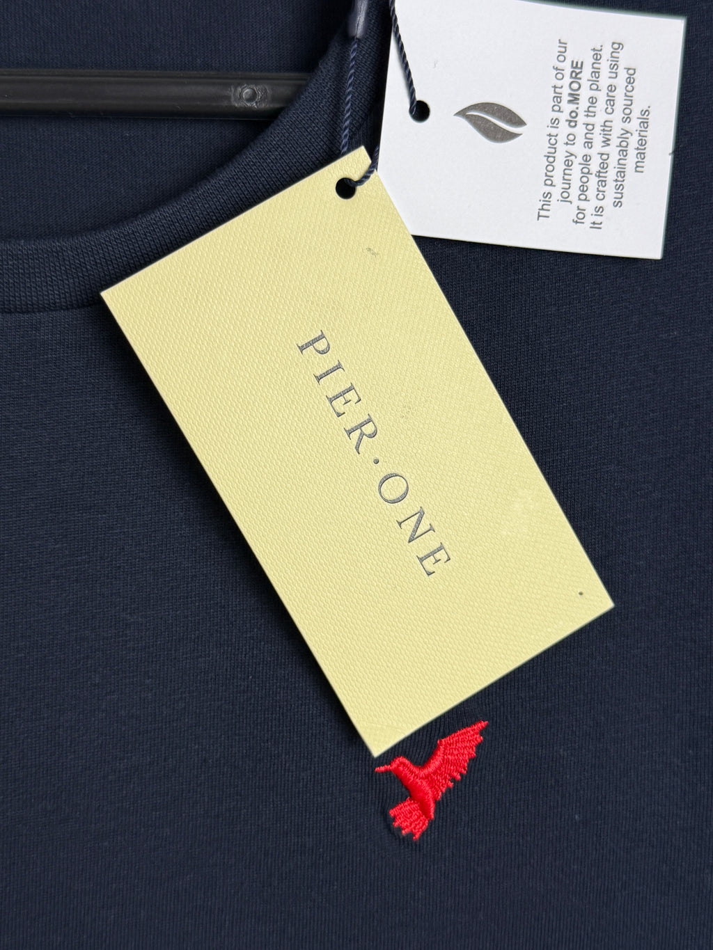 Pier-One label on a product with a red tag against a dark background