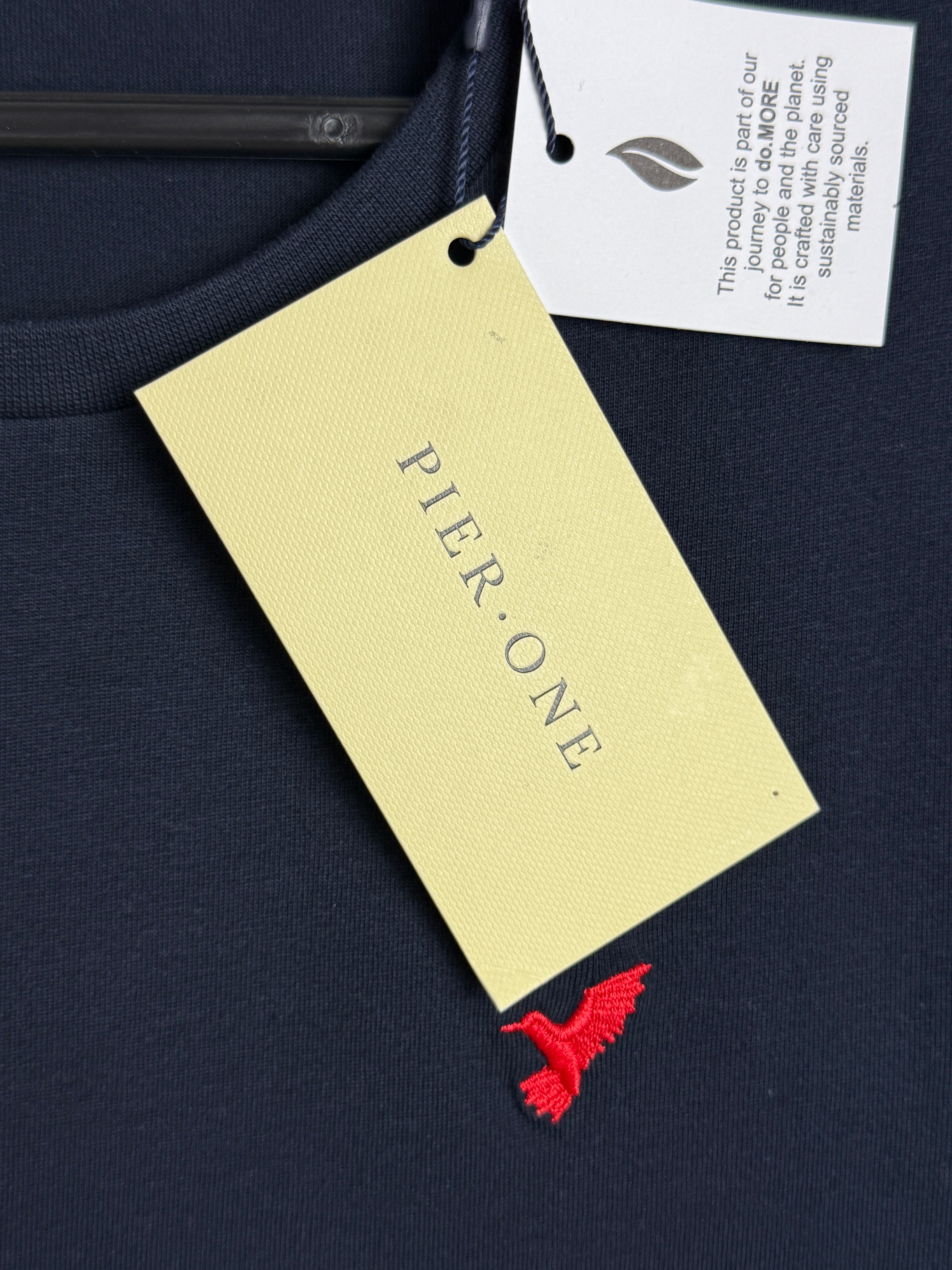 Pier-One label on a product with a red tag against a dark background