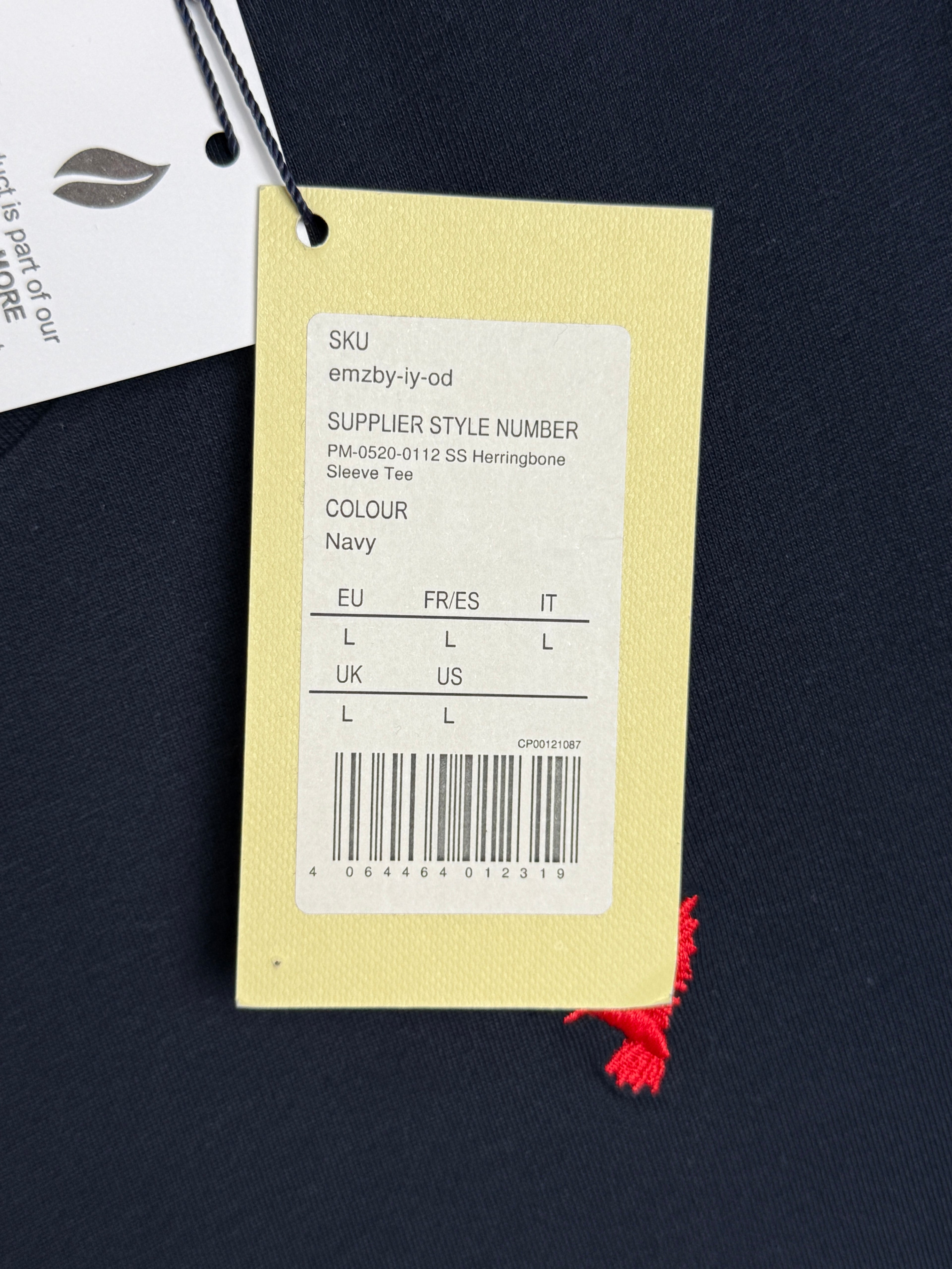 Clothing tag with size chart on a dark background