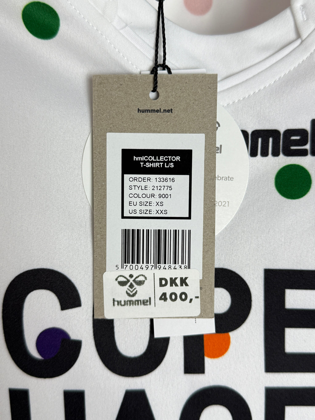Close-up of a clothing tag with brand logos on a white background